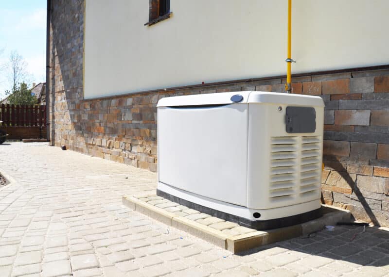 backup generator outside next to brick wall