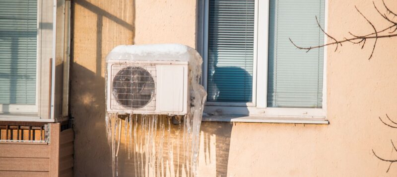 a frozen outdoor ac unit covered in ice